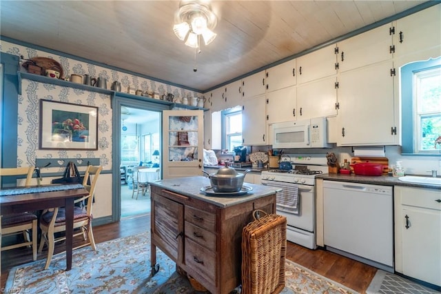 kitchen with sink, white cabinets, white appliances, dark hardwood / wood-style flooring, and ceiling fan