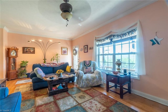 living room with ceiling fan, crown molding, and wood-type flooring