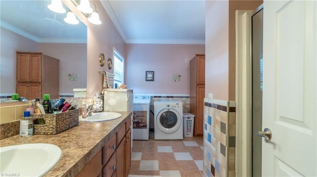 bathroom with vanity, crown molding, washer and dryer, and an enclosed shower