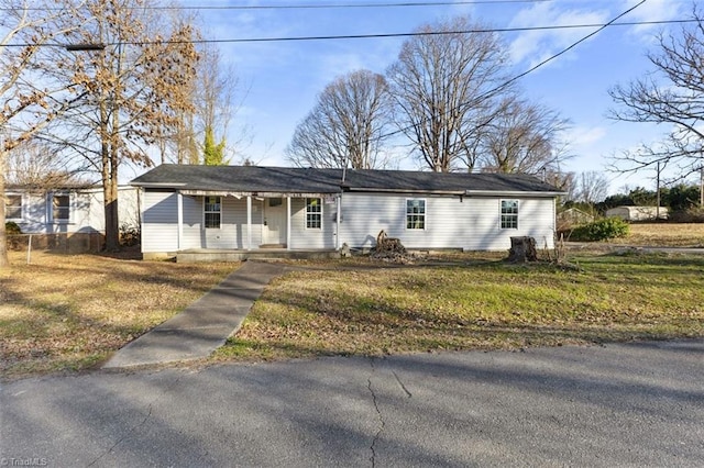 ranch-style home featuring a front yard