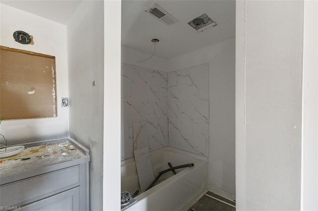 bathroom featuring visible vents, vanity, and tub / shower combination