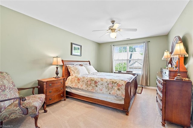 bedroom featuring light carpet, baseboards, visible vents, and a ceiling fan