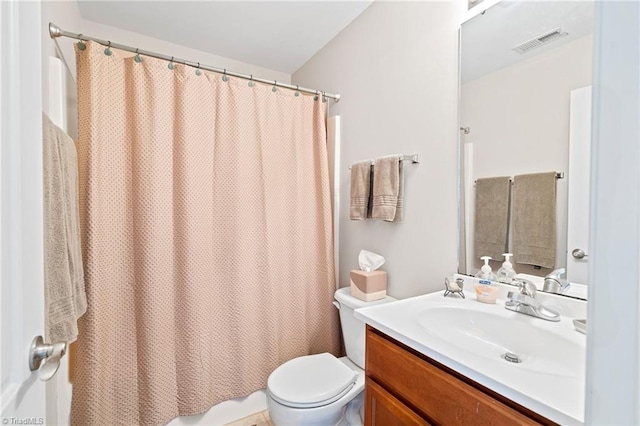 bathroom featuring toilet, visible vents, and vanity