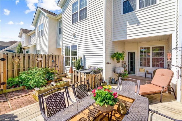 deck featuring outdoor dining area and fence