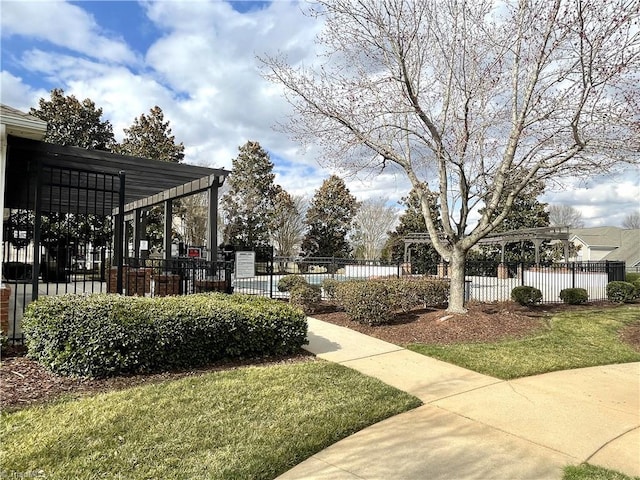 view of community featuring fence and a pergola