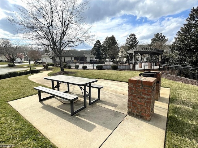 view of home's community featuring a yard, a patio, and fence