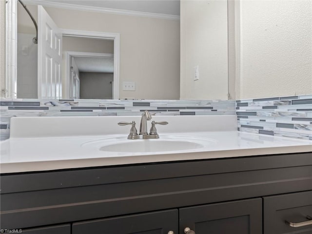 bathroom featuring vanity, crown molding, and decorative backsplash