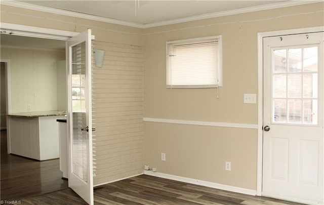 interior space with plenty of natural light, ornamental molding, baseboards, and wood finished floors