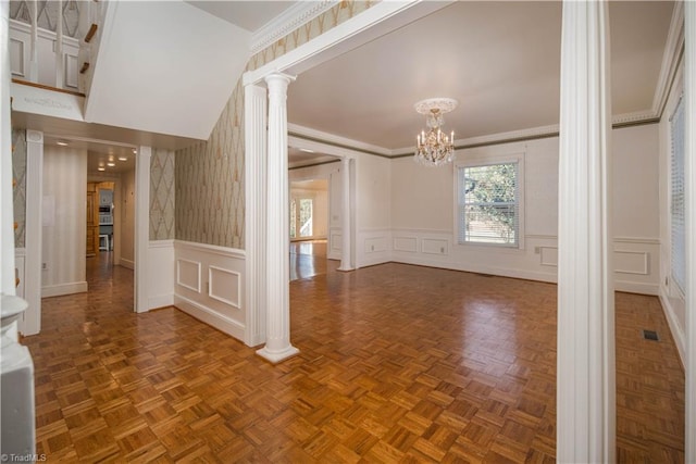 interior space with parquet flooring, decorative columns, crown molding, and an inviting chandelier