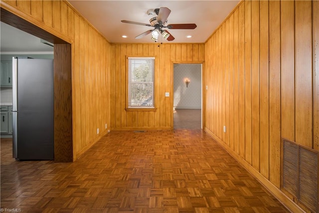 hallway featuring wood walls and parquet floors