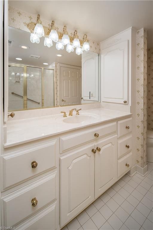 bathroom with vanity, walk in shower, toilet, and tile patterned floors