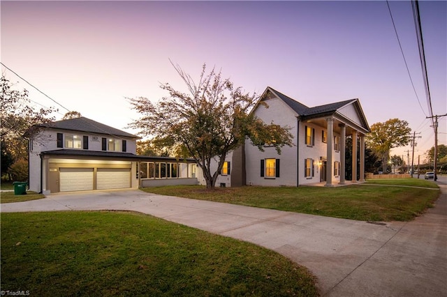 view of front of home with a yard and a garage