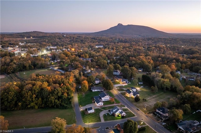 aerial view at dusk featuring a mountain view