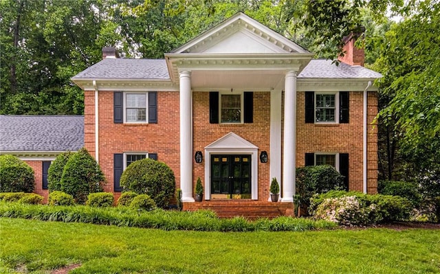 226 Cedar Trl, Winston-Salem, NC 27104 - greek revival inspired property with a chimney, a front lawn, and brick siding