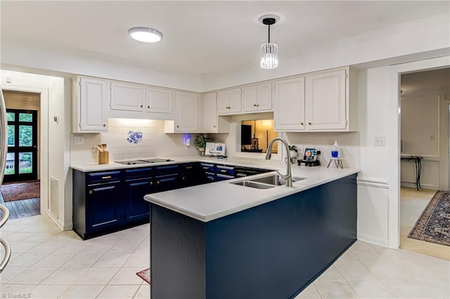 226 Cedar Trl, Winston-Salem, NC 27104 - kitchen featuring a sink, blue cabinets, light tile patterned floors, and light countertops