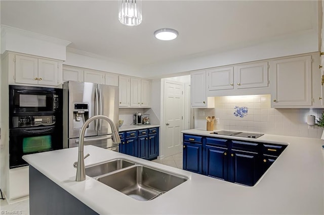 226 Cedar Trl, Winston-Salem, NC 27104 - kitchen with blue cabinetry, black appliances, a sink, tasteful backsplash, and white cabinetry