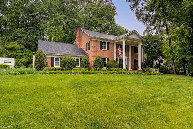 226 Cedar Trl, Winston-Salem, NC 27104 - neoclassical / greek revival house featuring a front yard, a chimney, and brick siding