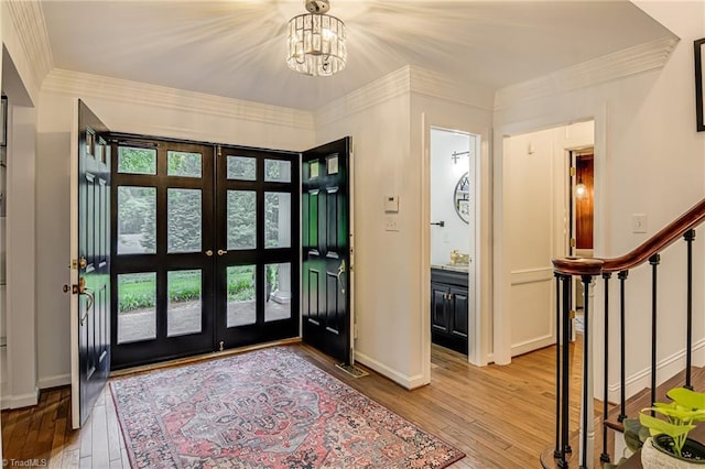 226 Cedar Trl, Winston-Salem, NC 27104 - entrance foyer with french doors, light wood finished floors, a chandelier, healthy amount of natural light, and ornamental molding