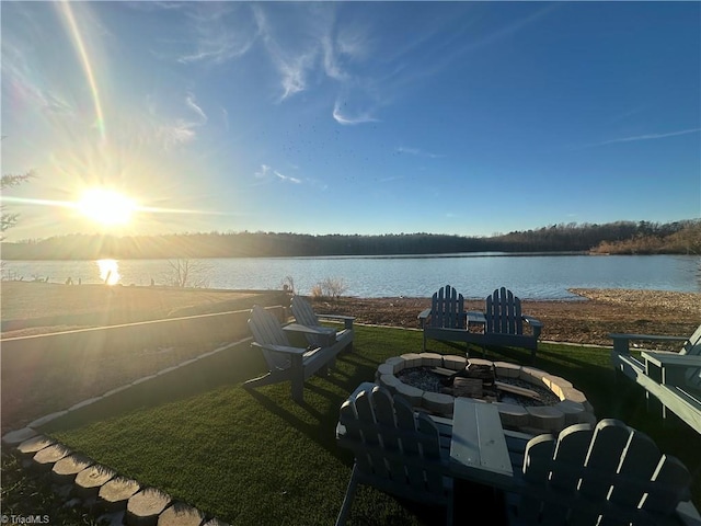 exterior space featuring a water view and an outdoor fire pit