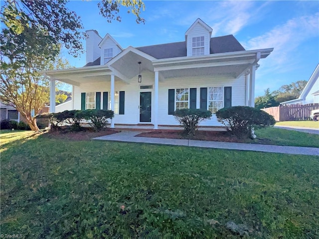 cape cod home with a front yard and a porch