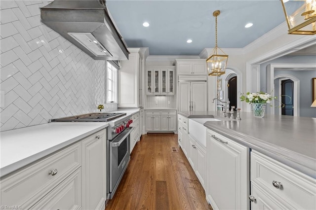 2990 Reynolds Sq, Winston-Salem, NC 27106 - kitchen with designer range, exhaust hood, white cabinetry, tasteful backsplash, and pendant lighting