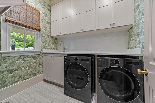 2990 Reynolds Sq, Winston-Salem, NC 27106 - washroom featuring wallpapered walls, washing machine and clothes dryer, and cabinet space