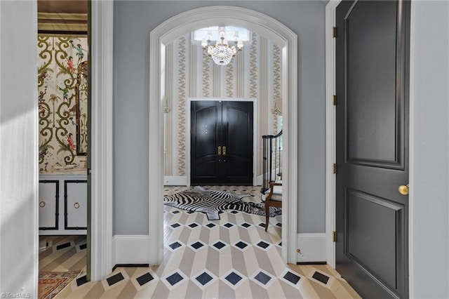 2990 Reynolds Sq, Winston-Salem, NC 27106 - entryway with a chandelier, arched walkways, and wallpapered walls