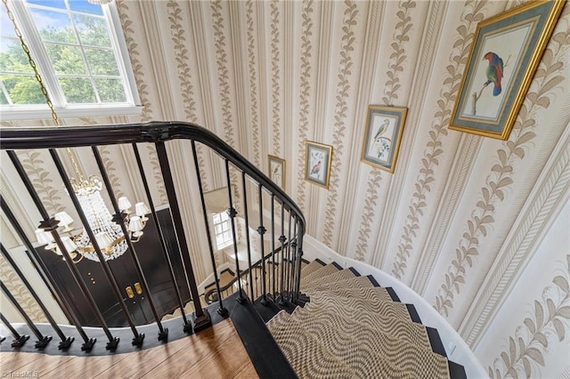 2990 Reynolds Sq, Winston-Salem, NC 27106 - staircase featuring wallpapered walls and a chandelier