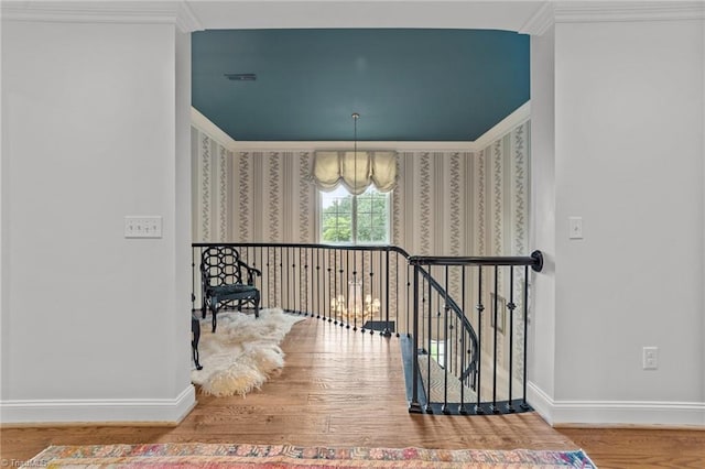 2990 Reynolds Sq, Winston-Salem, NC 27106 - stairway featuring wood finished floors, crown molding, and a chandelier