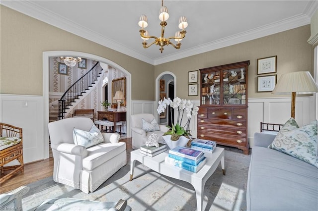 2990 Reynolds Sq, Winston-Salem, NC 27106 - living room featuring a chandelier, arched walkways, stairway, ornamental molding, and a decorative wall