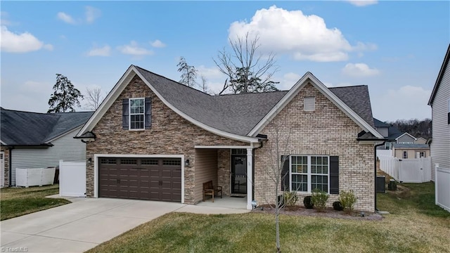 view of front of home with a garage and a front lawn