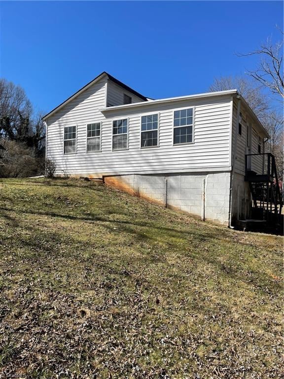 view of property exterior with a lawn