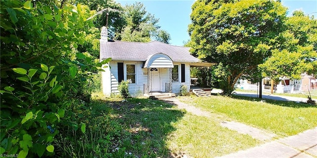 bungalow-style home with a front yard and a chimney