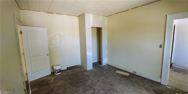 unfurnished room featuring concrete flooring