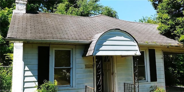 exterior view of a shingled roof and a chimney