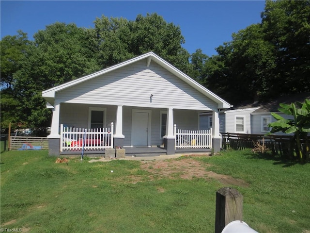 view of front of property with covered porch and a front yard