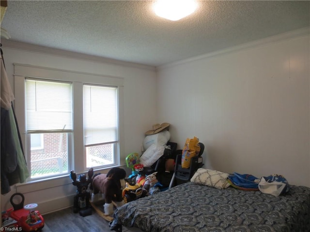 bedroom featuring a textured ceiling and ornamental molding