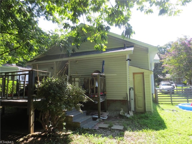 back of house with a lawn