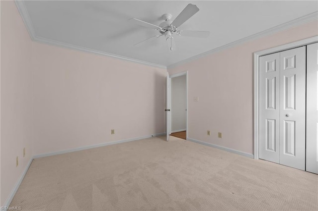unfurnished bedroom with baseboards, light colored carpet, and ornamental molding