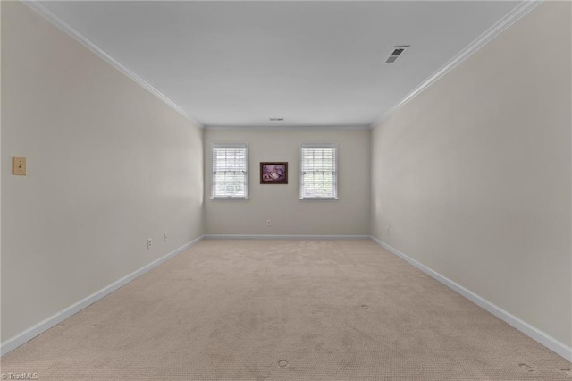 unfurnished room featuring light colored carpet, visible vents, and ornamental molding
