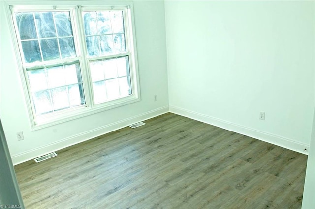 spare room featuring hardwood / wood-style floors