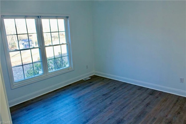 unfurnished room with dark wood-type flooring