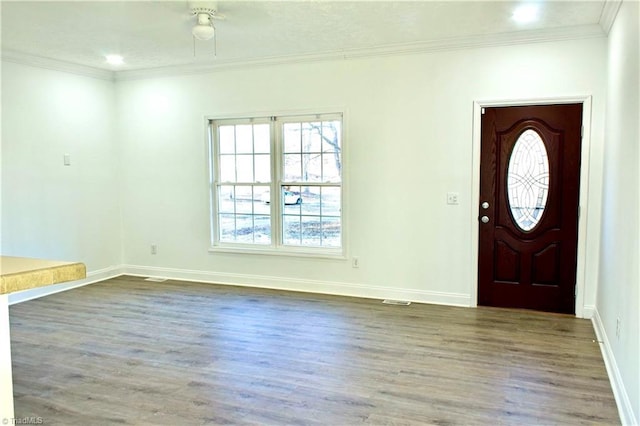 entrance foyer featuring ornamental molding and dark wood-type flooring