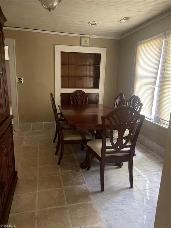 dining space featuring ornamental molding