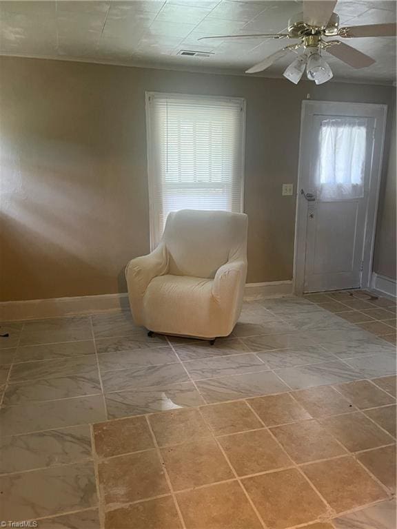 living area with ceiling fan