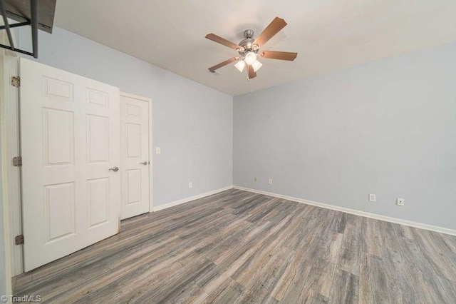 5306 Forester Dr, High Point, NC 27265 - unfurnished bedroom with wood finished floors, baseboards, and a ceiling fan