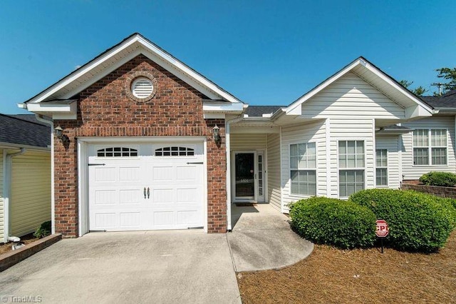 5306 Forester Dr, High Point, NC 27265 - view of front facade featuring concrete driveway, a garage, and brick siding