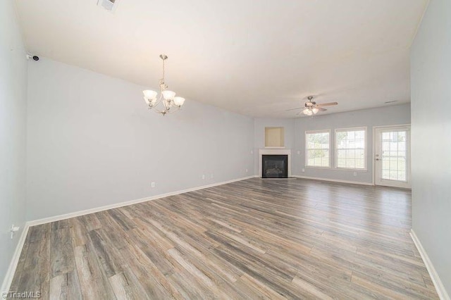 5306 Forester Dr, High Point, NC 27265 - unfurnished living room with wood finished floors, baseboards, a ceiling fan, a chandelier, and a fireplace