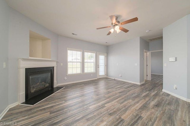 5306 Forester Dr, High Point, NC 27265 - unfurnished living room featuring wood finished floors, a ceiling fan, a glass covered fireplace, and baseboards