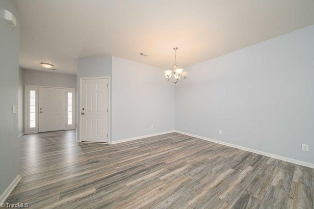 5306 Forester Dr, High Point, NC 27265 - spare room with a chandelier, wood finished floors, and baseboards